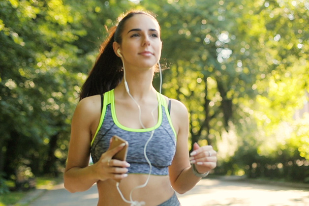 Girl with a tower in front of a mirror on a bathroom